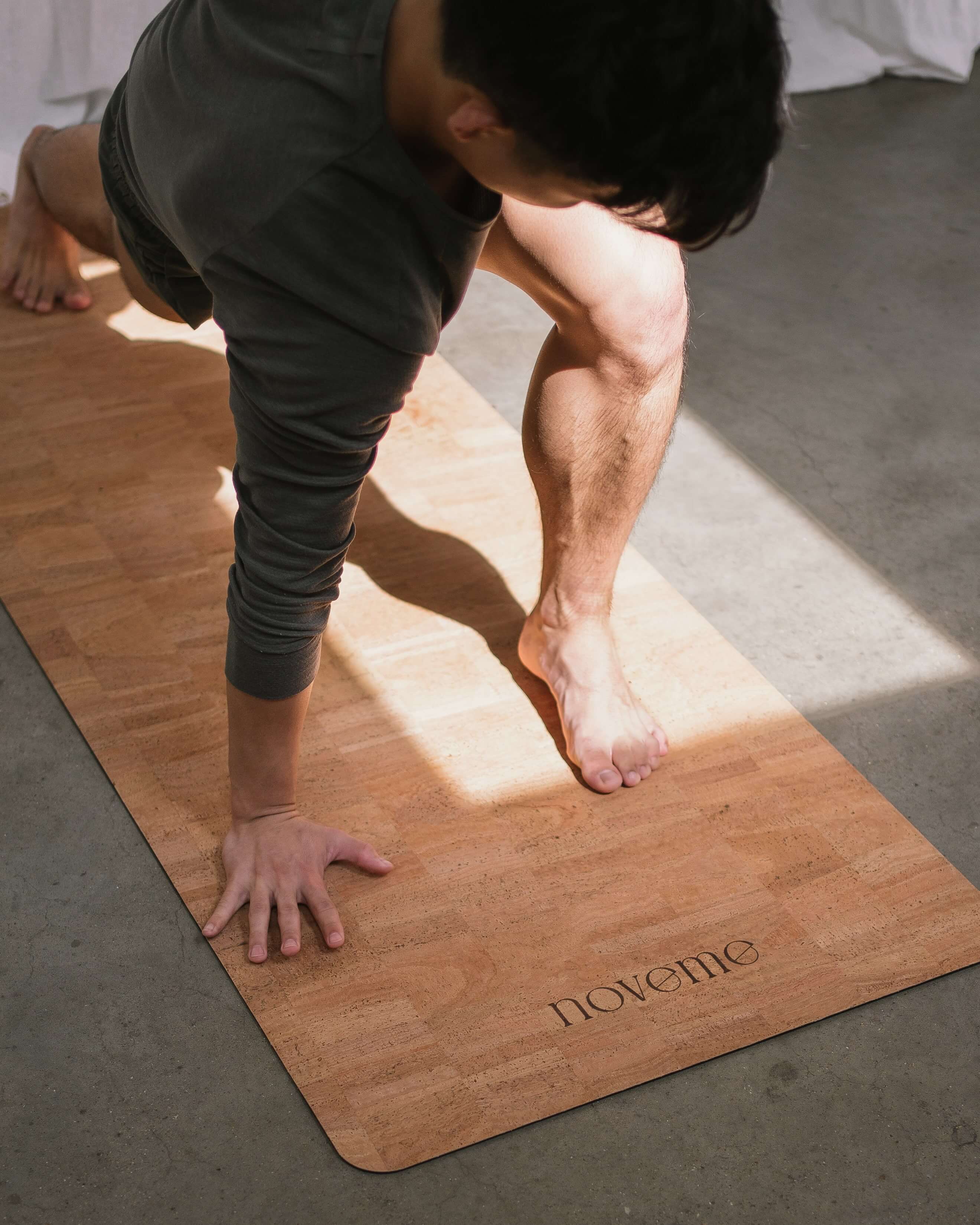 Middle age handsome sportman sitting on mat doing stretching yoga