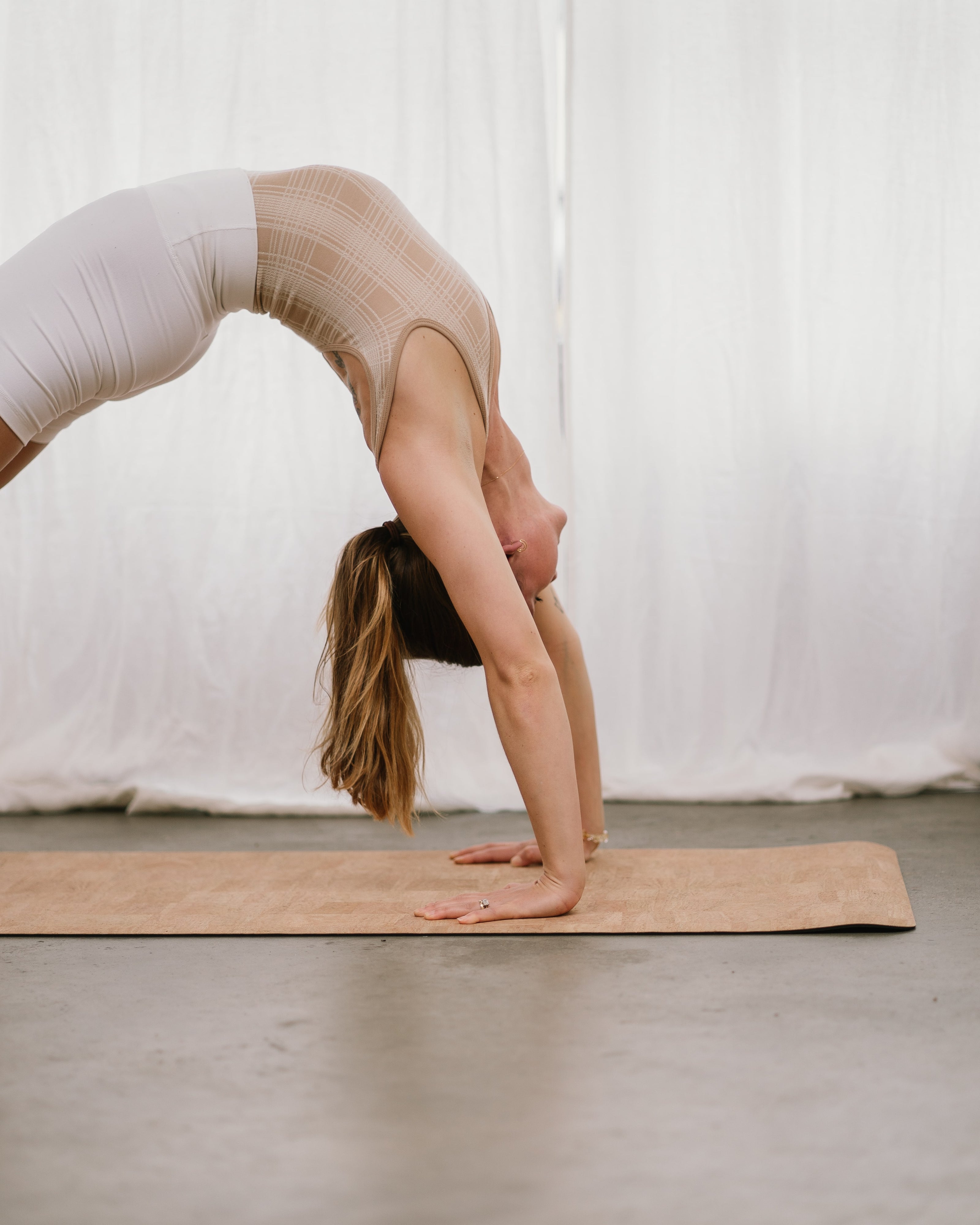 Jaime Hepburn doing bridge pose on a Noveme cork yoga mat