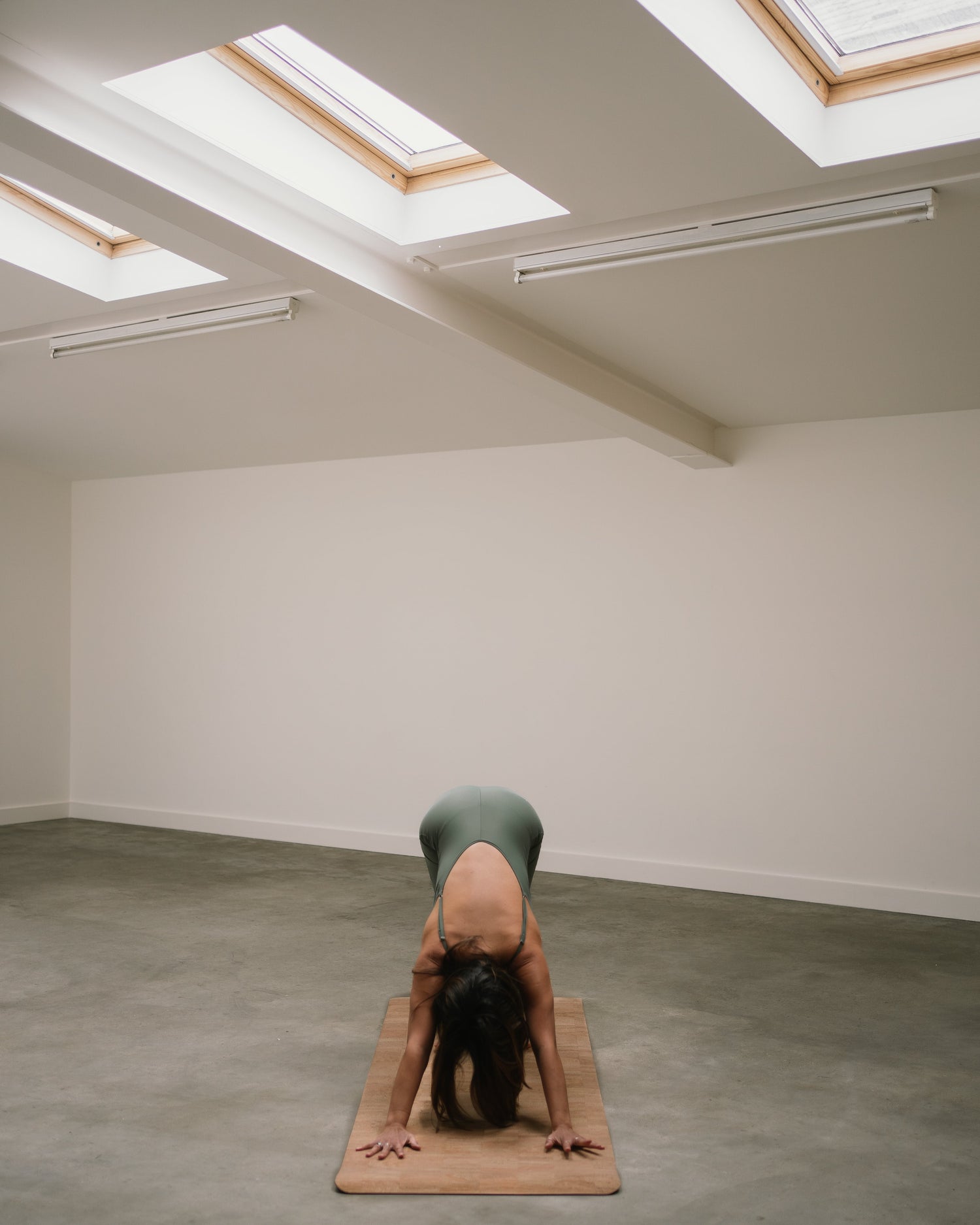 Yogi doing downward facing dog on a Noveme non-slip yoga mat