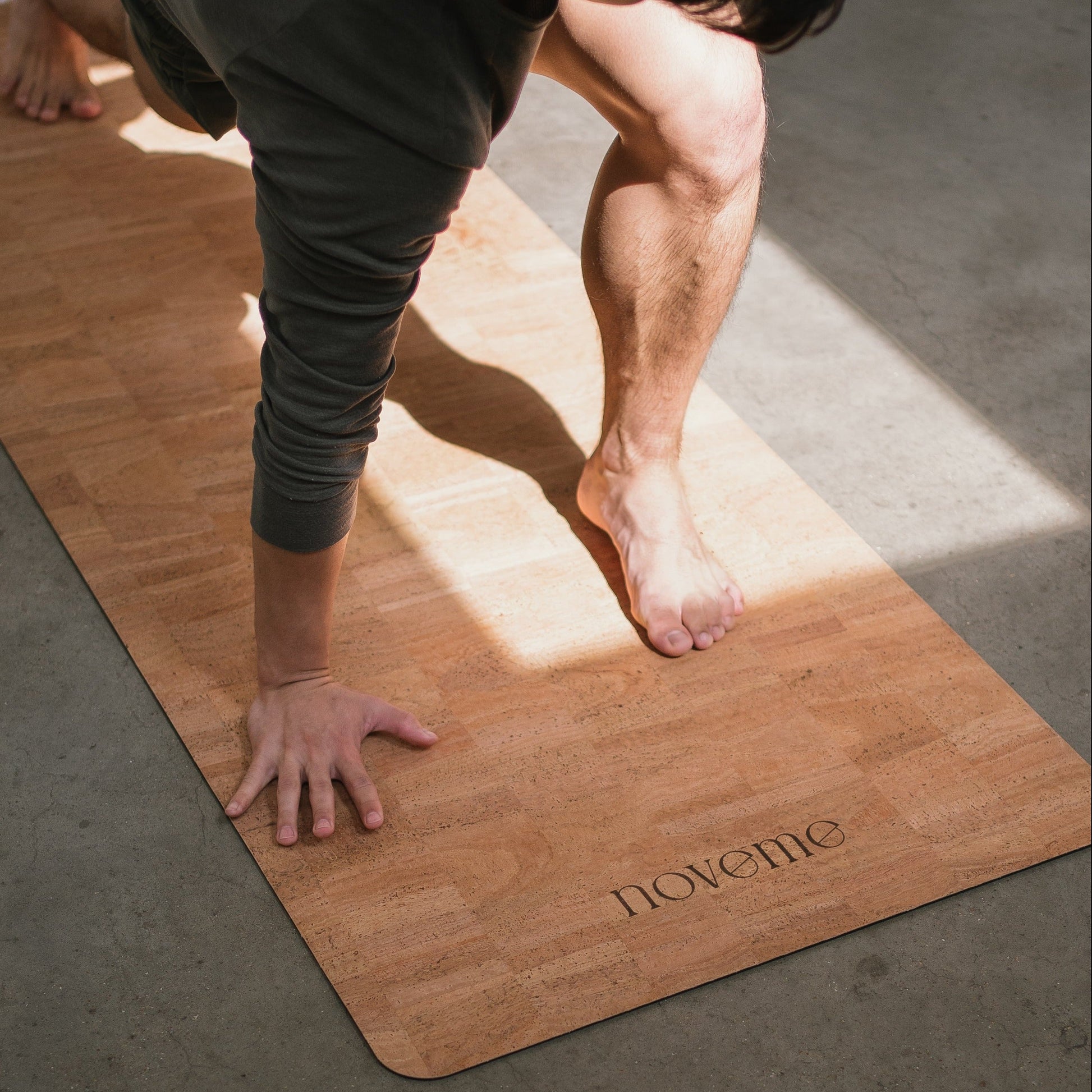 men practicing yoga on a Noveme natural cork yoga mat