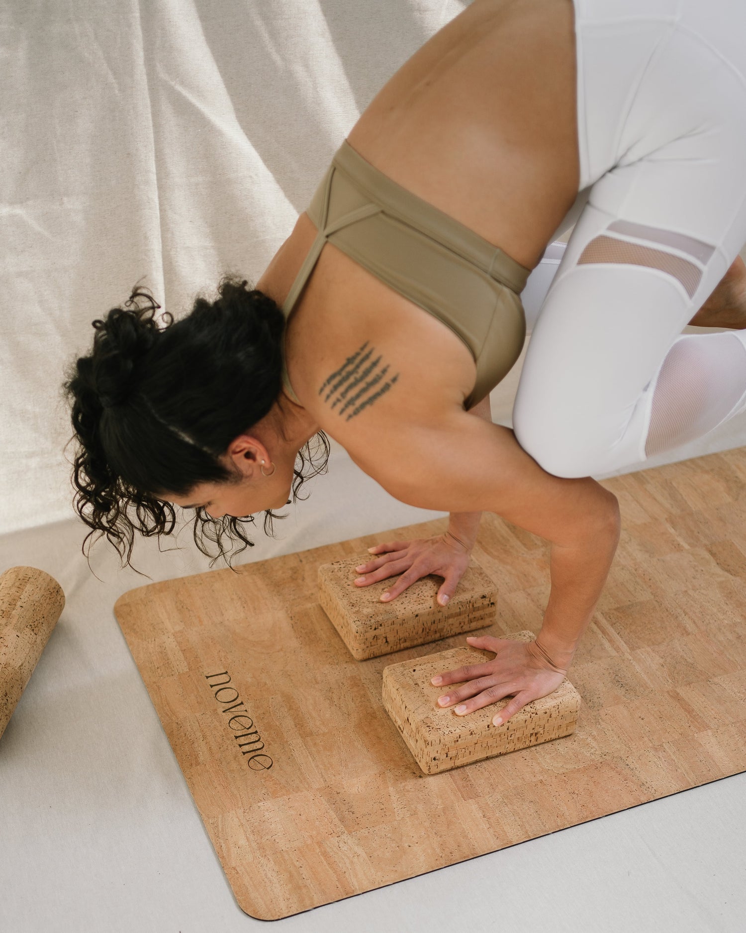 Yogi practicing using two Noveme cork yoga blocks on a Noveme cork yoga mat