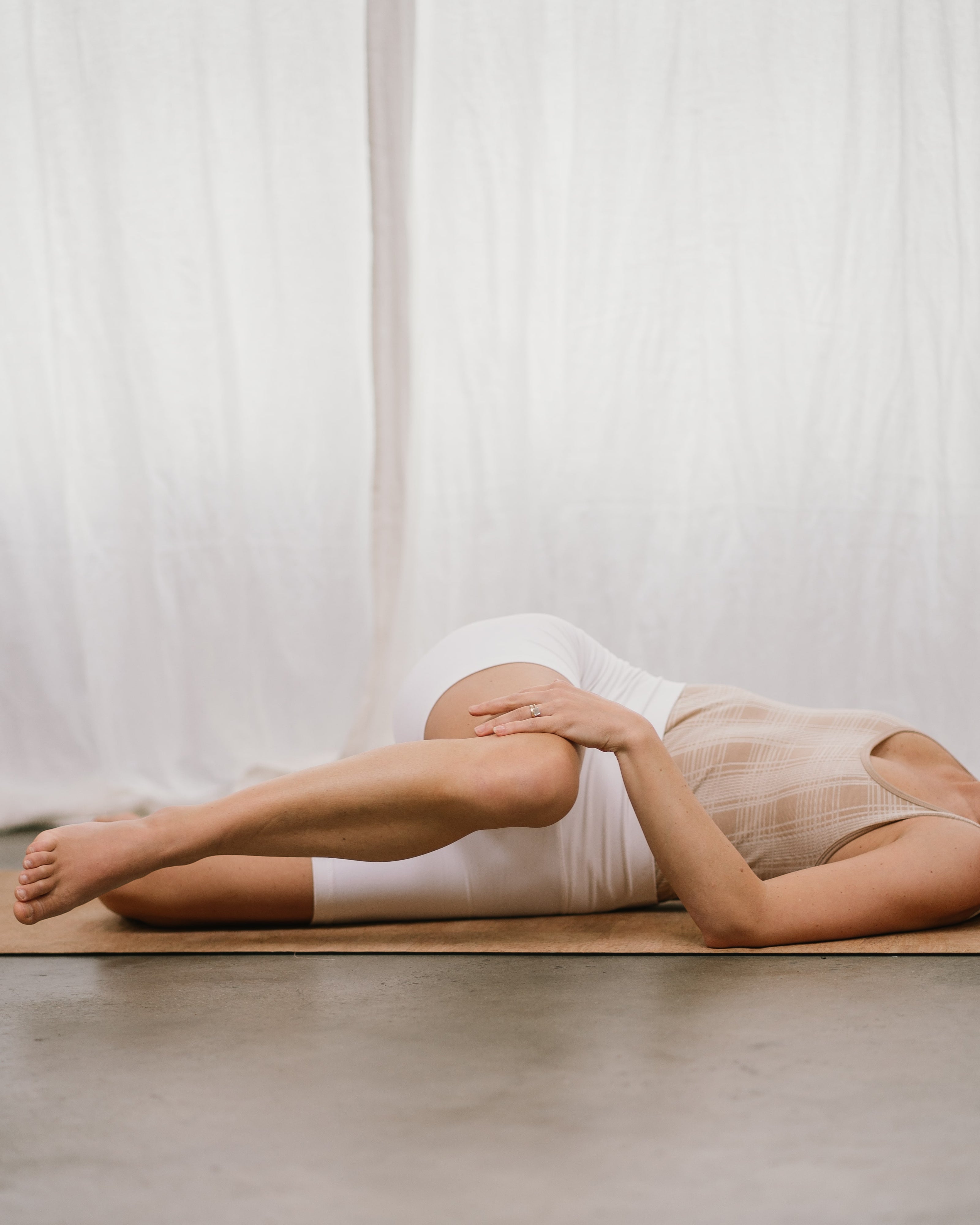 yogi stretching on a noveme cork yoga mat
