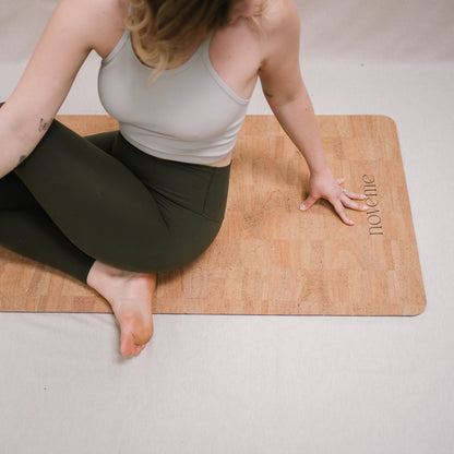 woman practicing yoga on a noveme cork yoga mat