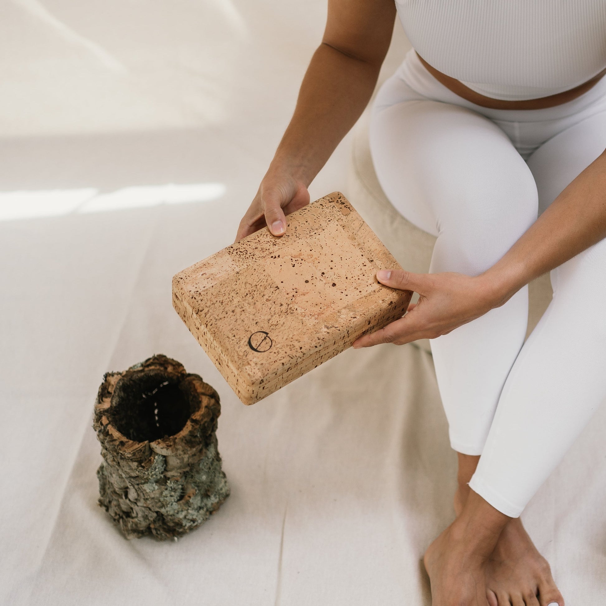 Woman holding a Noveme cork yoga block