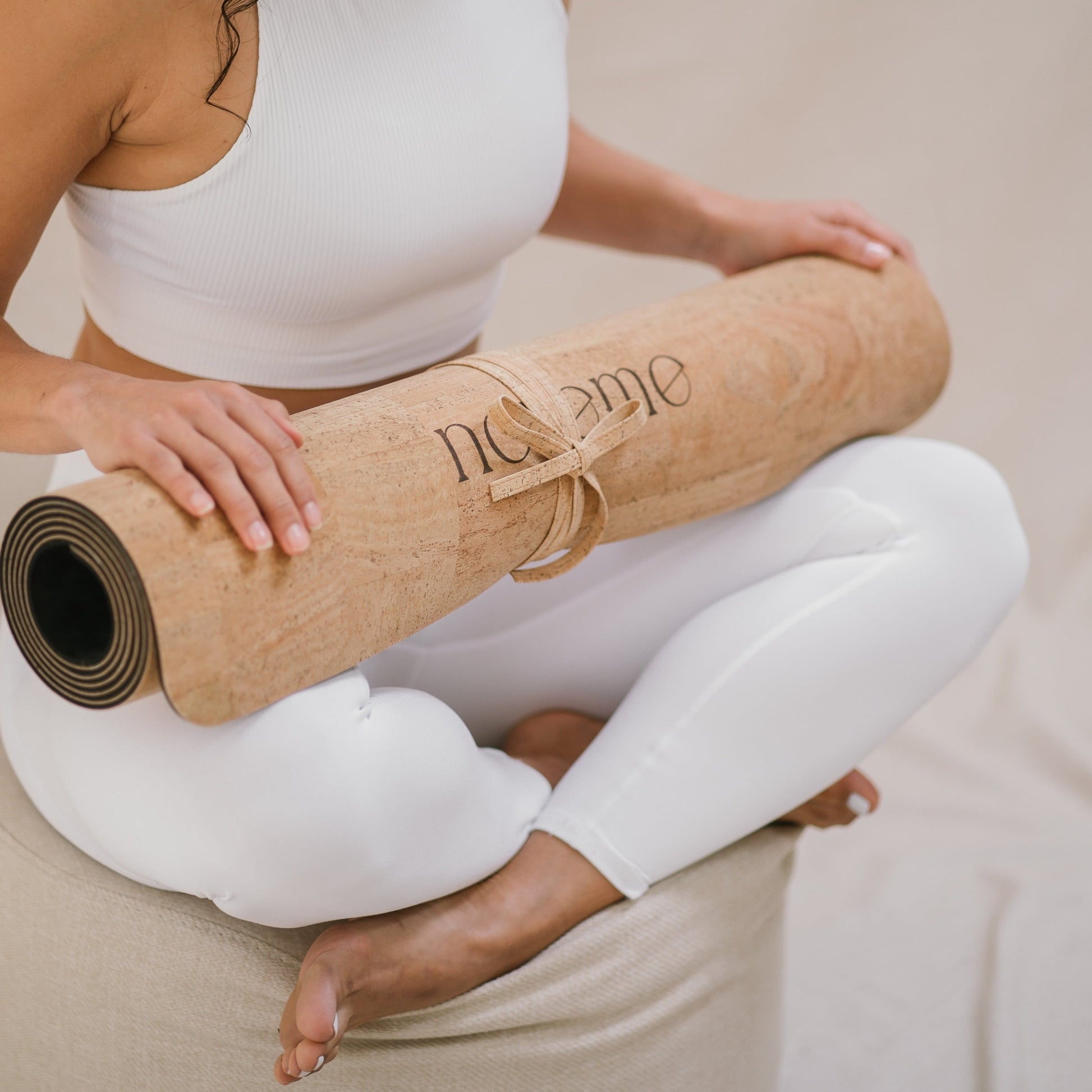 woman holding a Noveme cork yoga mat
