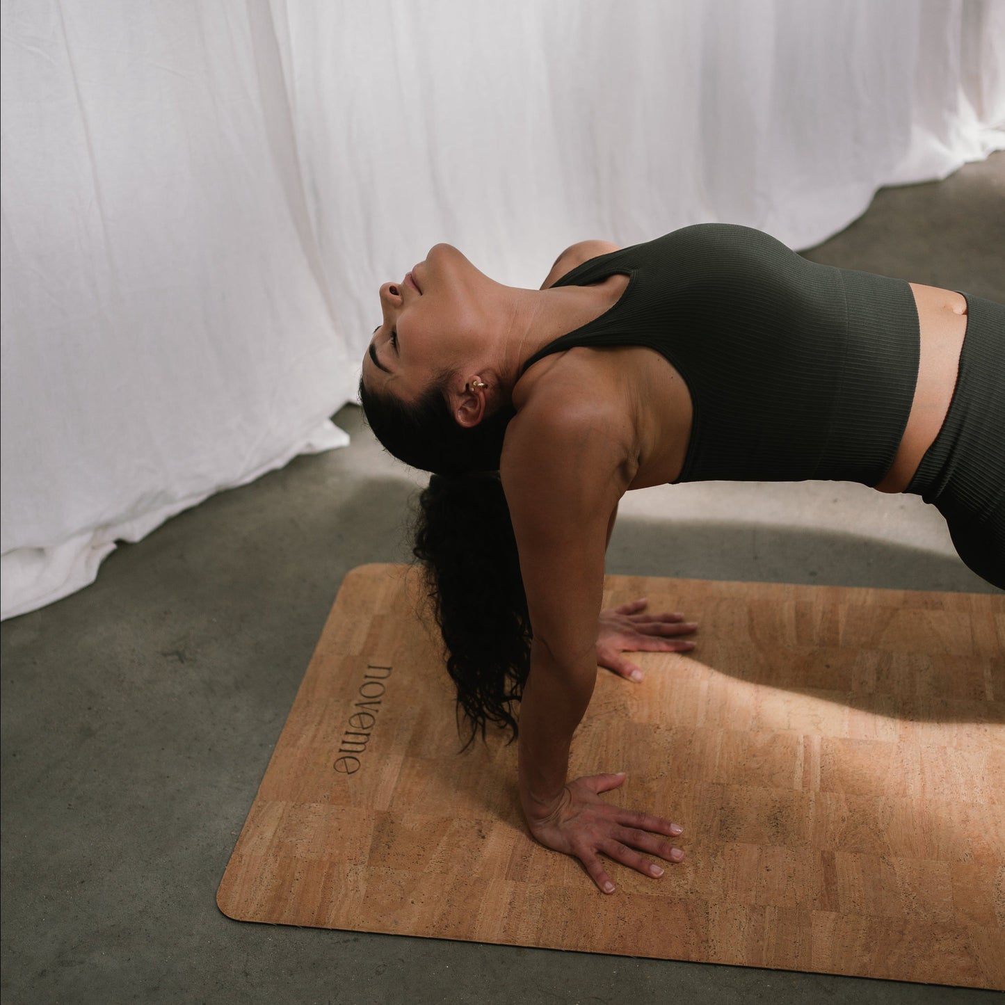 woman practicing yoga on a noveme cork yoga mat